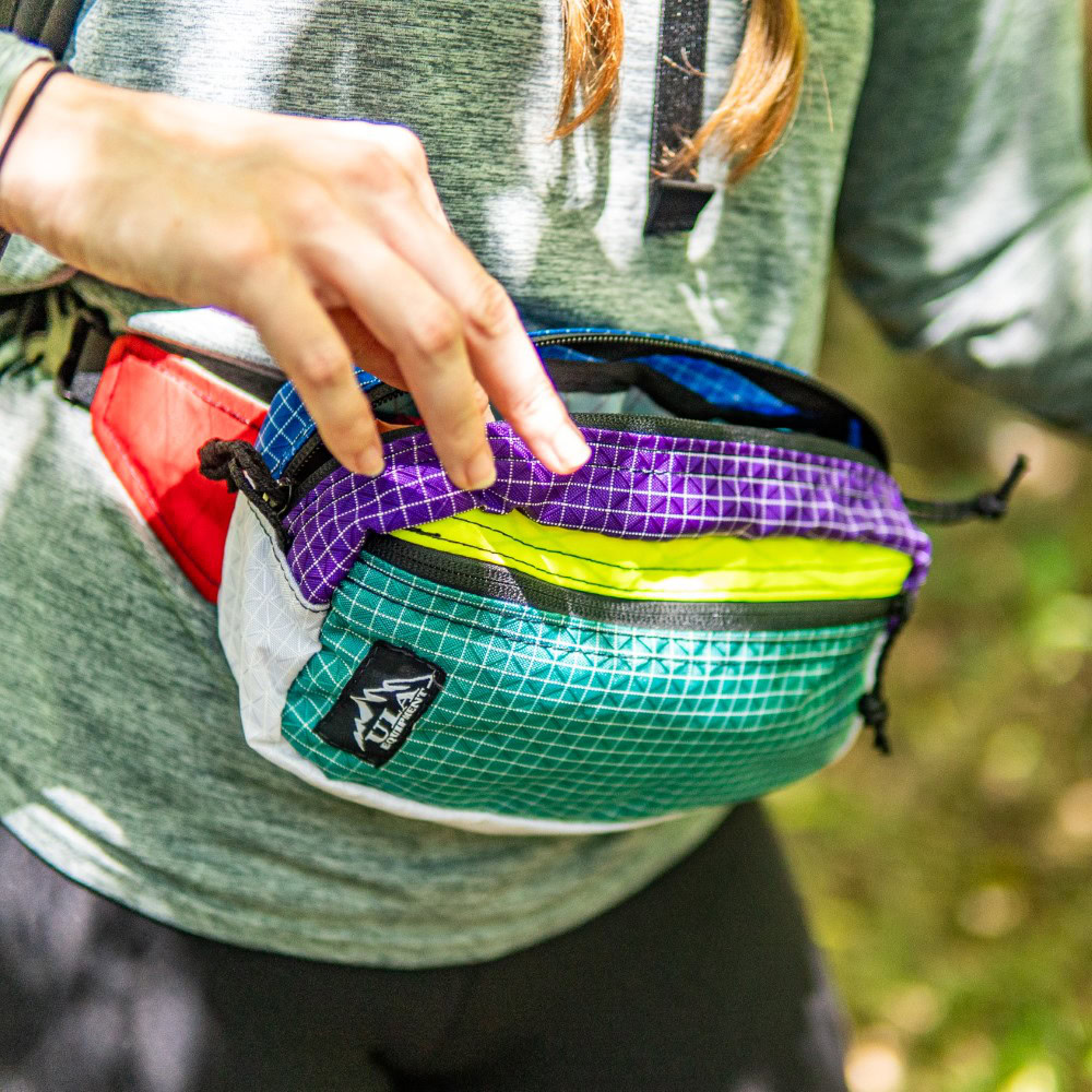 Backpacker looks in spacious inner compartment of Entropy Spare Tire Waist Pack