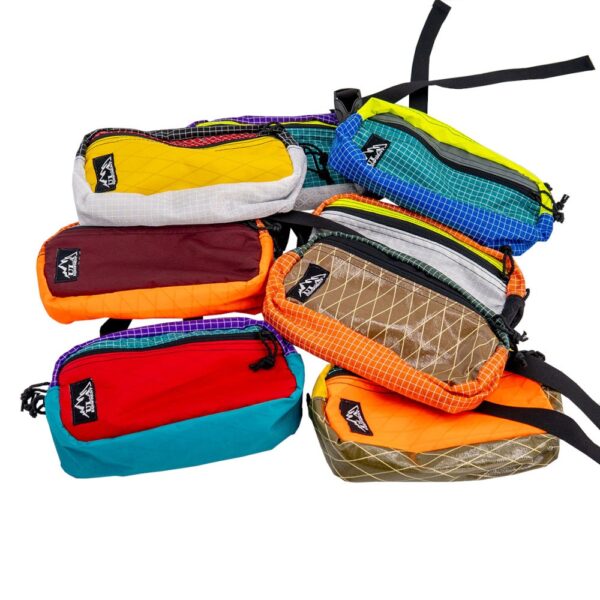 Different colors of ULA Entropy Spare Tire Waist Packs. These packs are made from fabric scraps to reduce landfill waste.