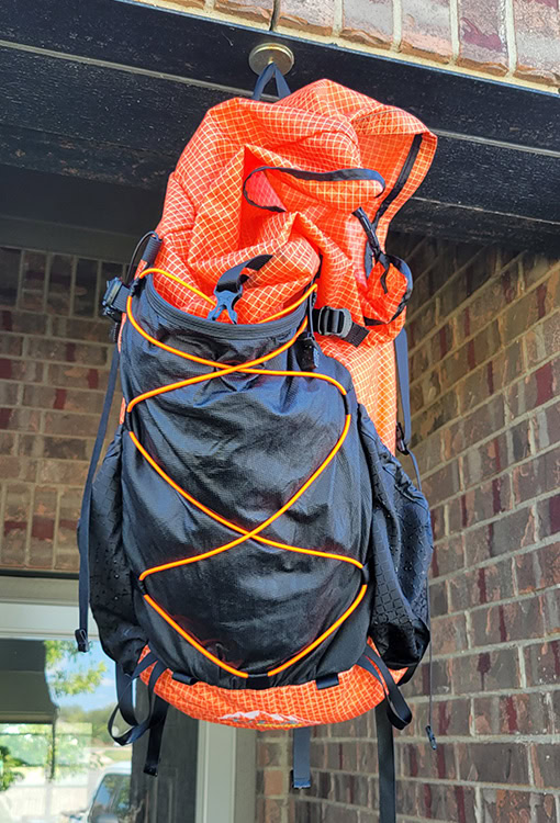 A BearVault being opened by a hiker. The BearVault also keeps your snacks from getting crushed.