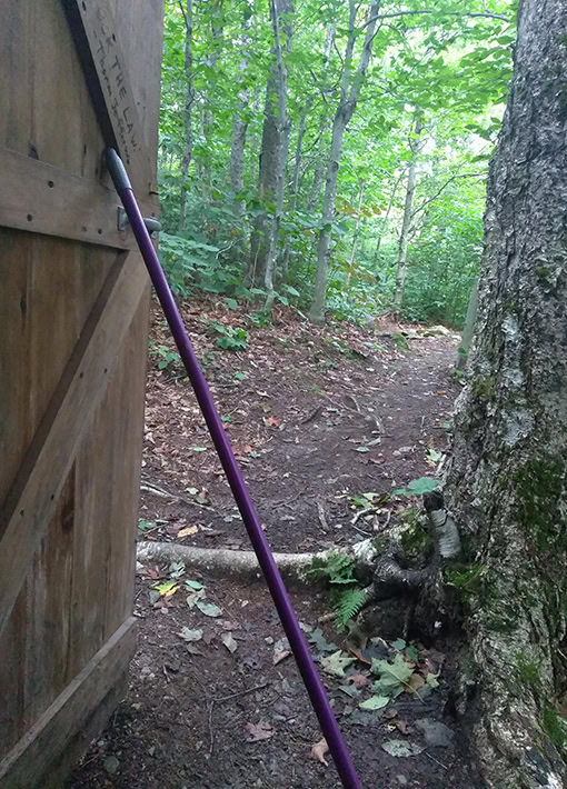 A BearVault being opened by a hiker. The BearVault also keeps your snacks from getting crushed.