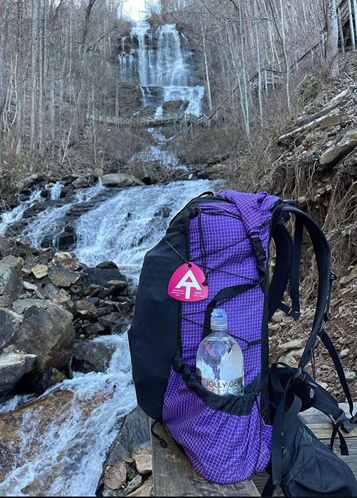 A BearVault being opened by a hiker. The BearVault also keeps your snacks from getting crushed.