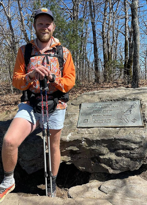 Backpacker puts a Bear Vault Bear Canister into a ULA CDT Backpack