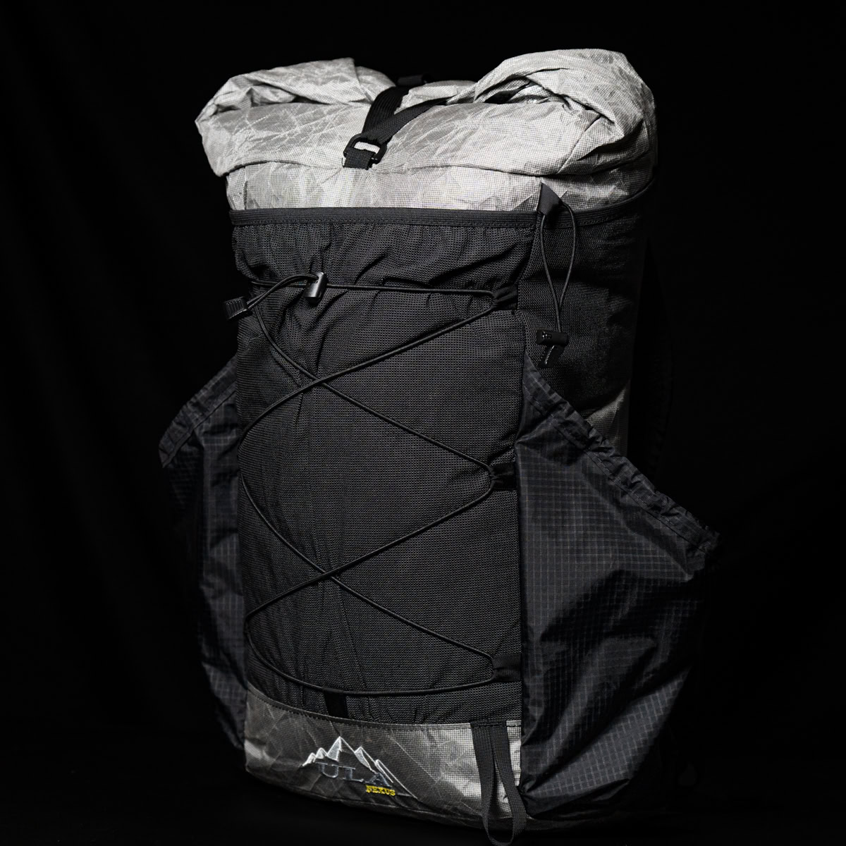 Backpacker puts a Bear Vault Bear Canister into a ULA CDT Backpack