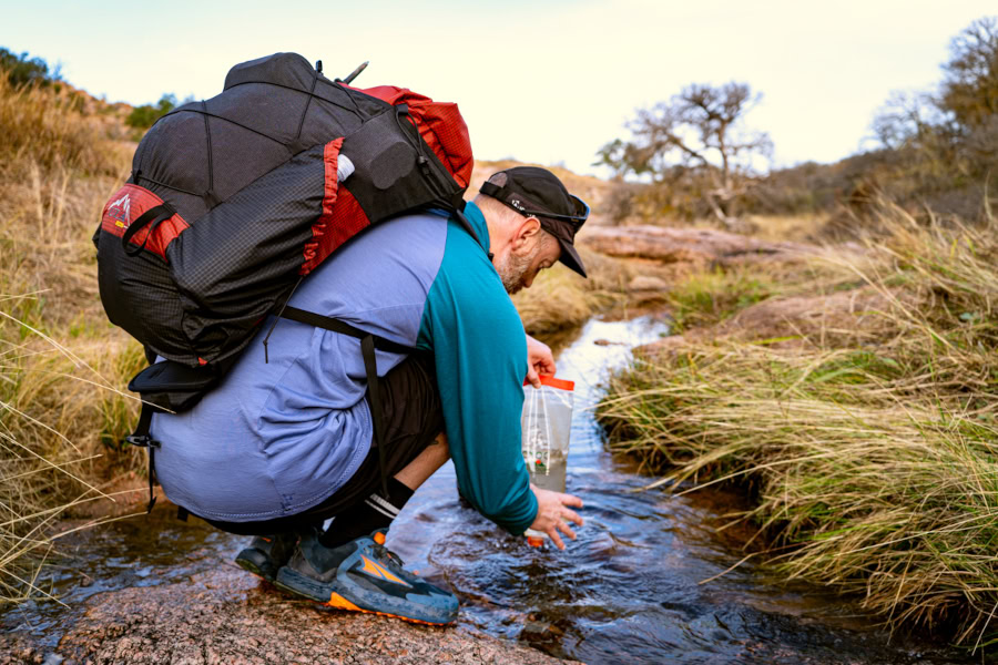 Backpacker wears frameless ULTRA X Nexus