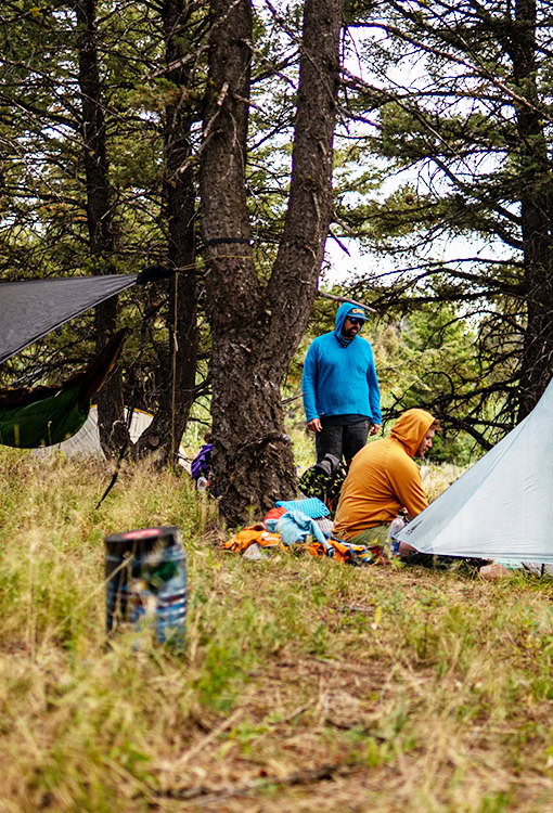 Backpacker puts a Bear Vault Bear Canister into a ULA CDT Backpack