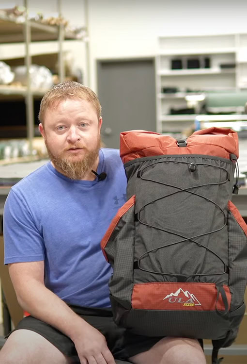 Backpacker puts a Bear Vault Bear Canister into a ULA CDT Backpack