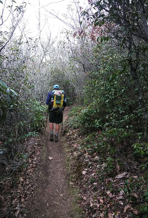 A BearVault being opened by a hiker. The BearVault also keeps your snacks from getting crushed.