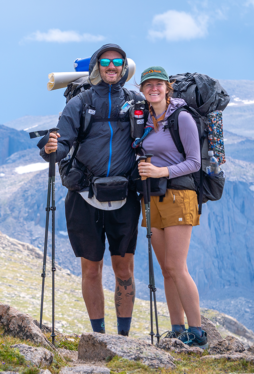 A BearVault being opened by a hiker. The BearVault also keeps your snacks from getting crushed.