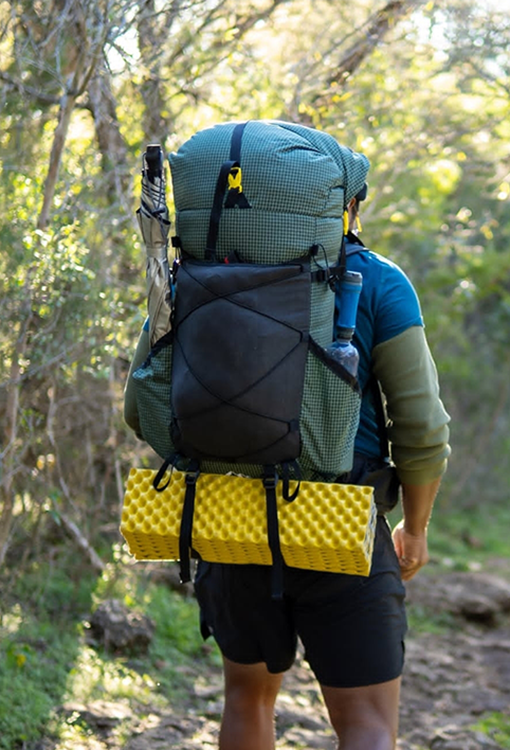 Backpacker puts a Bear Vault Bear Canister into a ULA CDT Backpack